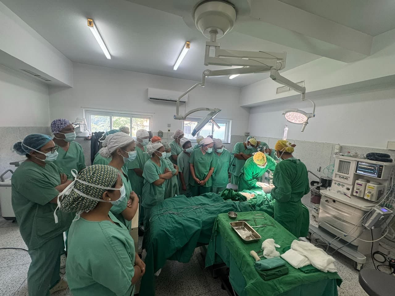 Participants observing a procedure in the operating theatre